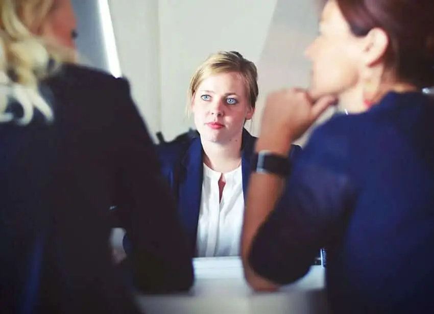 Three women in a discussion, representing polygraph support for immigration cases