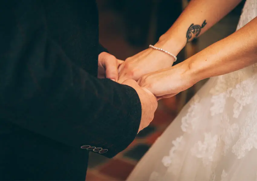 Couple holding hands, symbolizing trust and relationship commitment