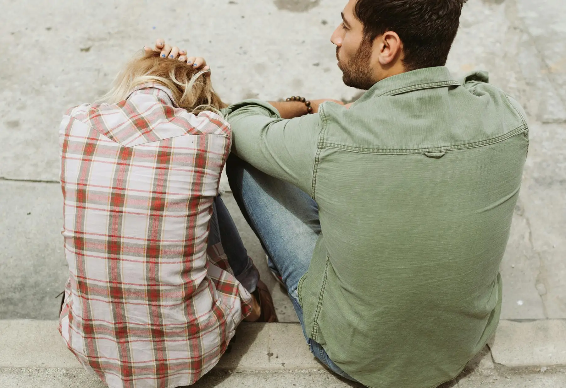 Couple sitting apart, dealing with relationship challenges